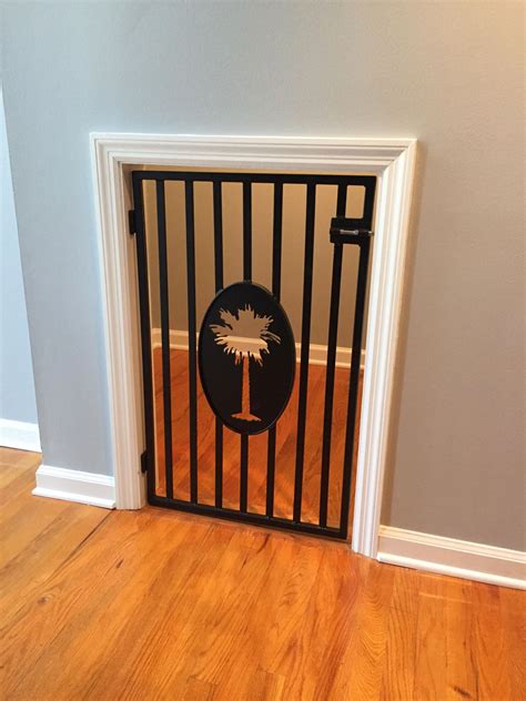 A Black Gate With A Palm Tree Painted On It In The Corner Of A Room