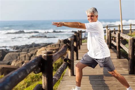 Fit Senior Man Exercising At The Beach — Stock Photo © Michaeljung