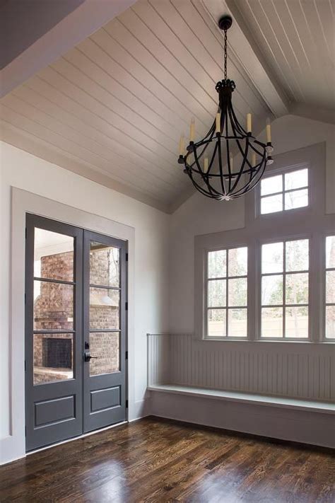 I love both traditional and cottage styles, and it ties into both nicely. Gray cottage mudroom features a gray shiplap vaulted ...