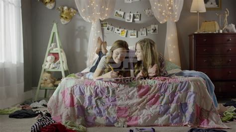 Medium Shot Of Teenage Girls Doing Homework On Bed Youtube