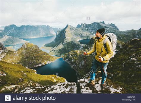 Bearded Man Traveler Standing On Cliff Mountain In Norway Traveling
