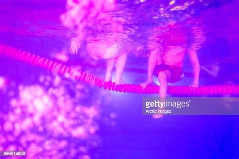 Two Teenage Girls Swimming Underwater In Swimming Pool Photos And