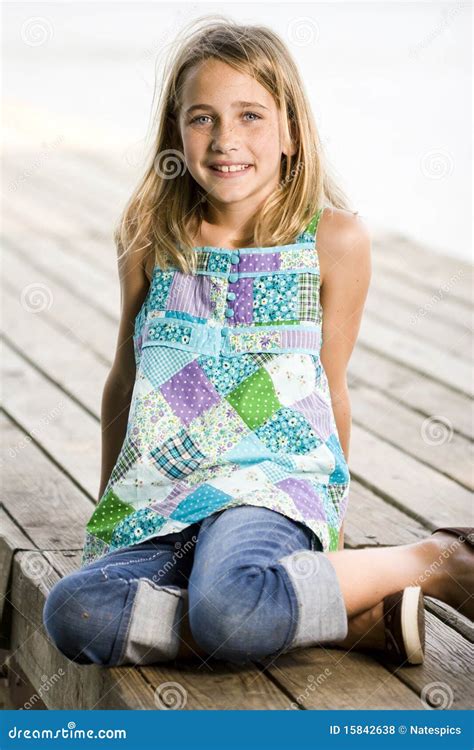 Young Tween Girl Sitting On A Pier Stock Photo Image Of Hair Jeans