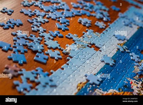 Partially Solved Jigsaw Puzzle With Scattered Puzzle Pieces On The