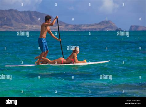 Couple On Standup Paddle Board In Hawaii Stock Photo Alamy