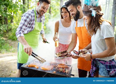 Group Of Friends Having A Barbecue And Grill Party In Nature Stock