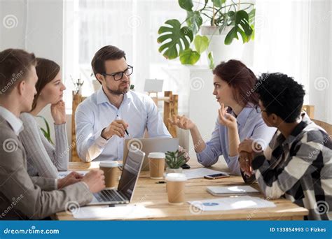 Diverse Employees Brainstorm At Business Office Meeting Stock Image