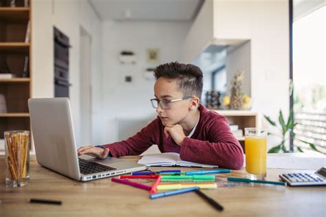 Boy Doing Homework On Laptop Review Of Myopia Management