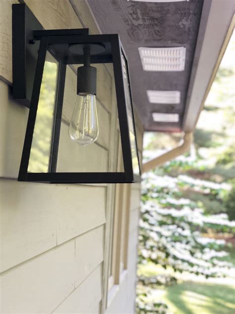 An Outdoor Light Hanging From The Side Of A House