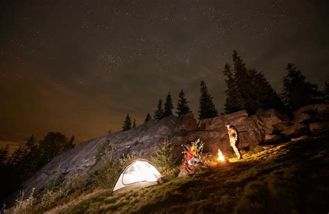 Premium Photo Night Camping With People Around Campfire Under Night