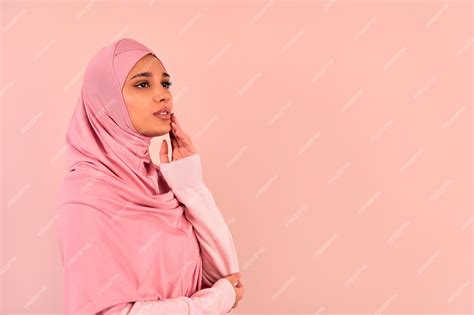 Premium Photo Portrait Of A Beautiful Young Modern Muslim Woman In A Pink Hijab Posing On A