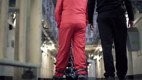 Prison Bars Prisoner In Shackles Chains Handcuffs Walking With Guards