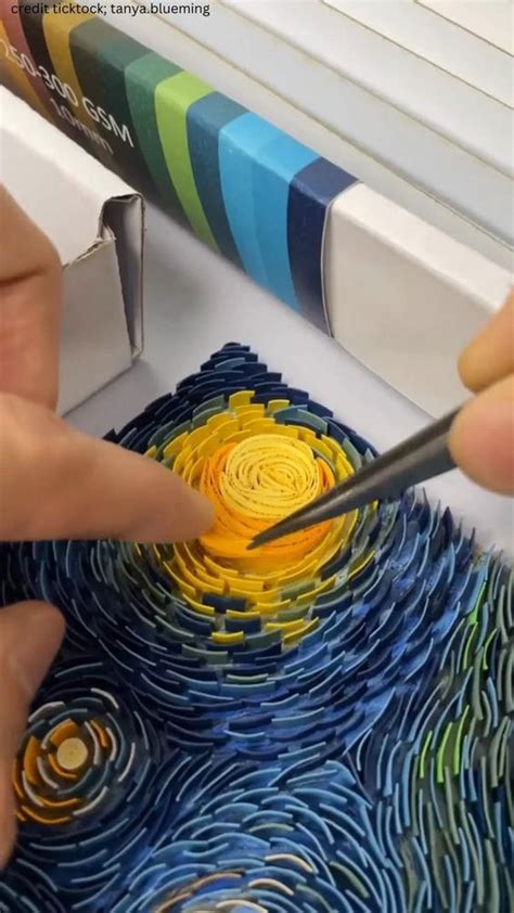 Two Hands Using Scissors To Cut Paper Art
