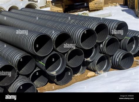 Plastic Pvc Pipes Stacked In Rows At A Construction Site On