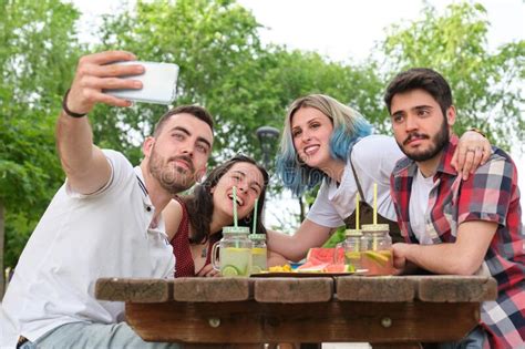 Group Of Happy Friends Taking A Selfie And Having Fun In A Park Stock