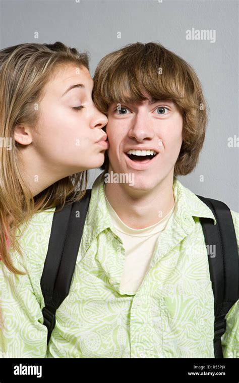 Girl Giving Boy A Kiss On The Cheek Stock Photo Alamy