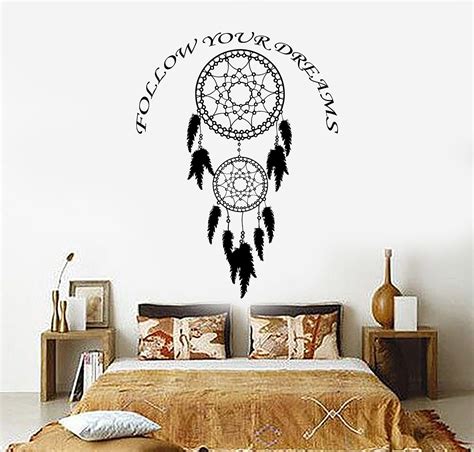 A Bedroom With A Bed And Wall Decal That Says Follow Your Dreams