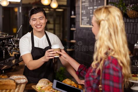 Smiling Waiter Serving A Coffee To A Customer Stock Image Image Of