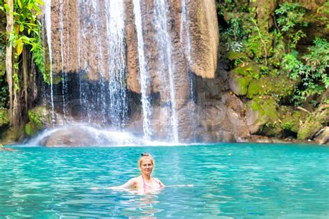 Young Woman Relaxes In Emerald Blue Lake Erawan National Park