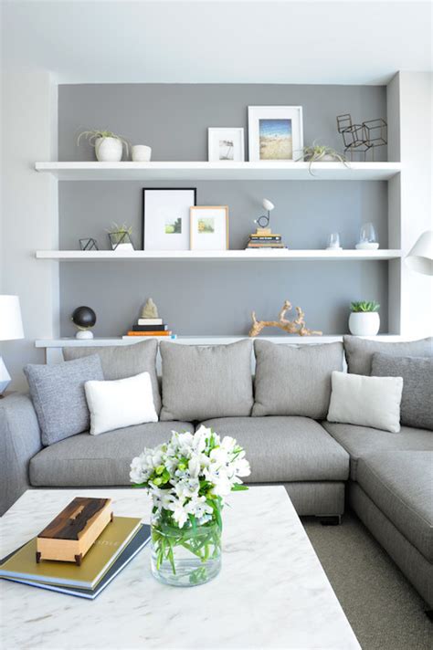 The couch underneath has sandy and modern cushions, while a rustic bell is pressed into the wall above the picture. Shelf Over Sofa - Contemporary - Living Room - Benjamin ...
