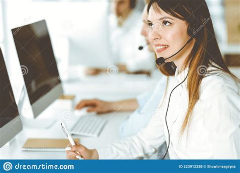 Group Of Diverse Operators At Work In Call Center Beautiful Asian Woman Sitting In Headset At
