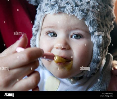 Baby Eating A Porridge With A Spoon Stock Photo Alamy