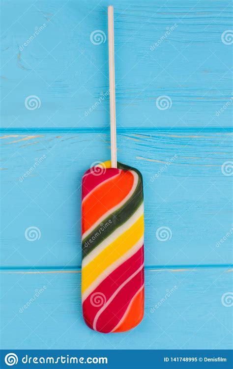 Multicolored Lollipop On Blue Background. Stock Image - Image of lick ...