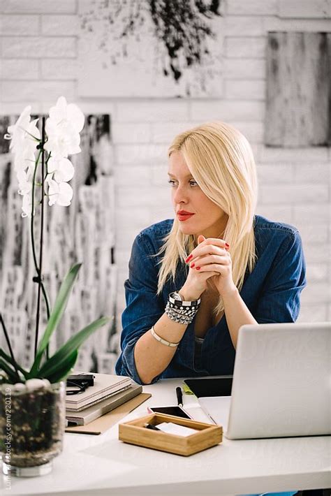 blonde businesswoman sitting at her desk by stocksy contributor lumina business women