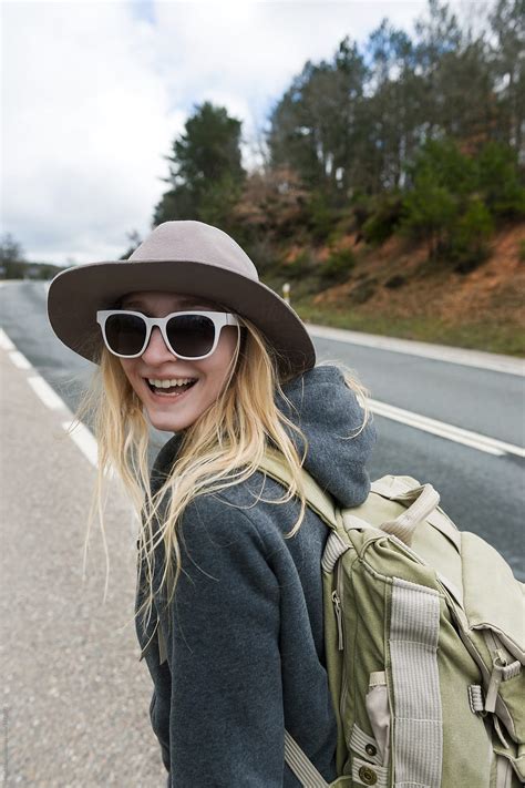 Smiling Woman Walking On Roadside Del Colaborador De Stocksy Milles