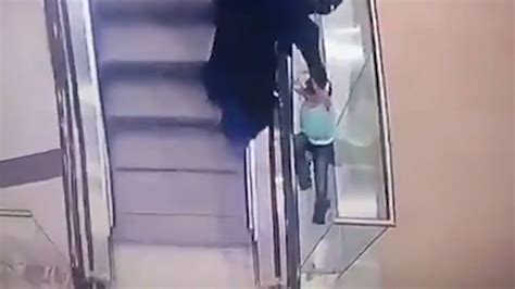horrifying moment girl aged 5 plunges down two floors after falling from escalator as aunt