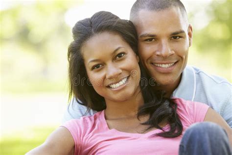 Portrait Of Romantic Young African American Couple In Park Stock Photo
