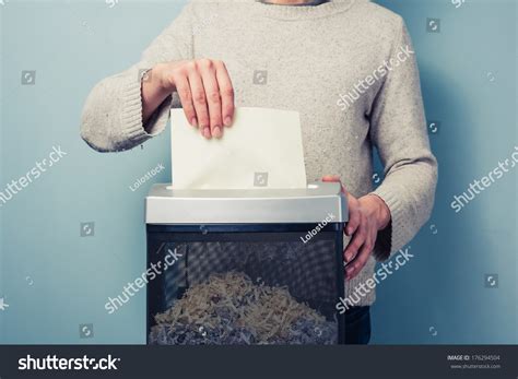 Man Is Shredding A Piece Of Paper Stock Photo 176294504 Shutterstock