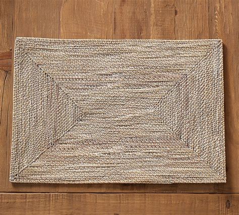 Feature with hand woven with the local artisan with round design. Tava Rattan Rectangle Placemat | Pottery barn, Pottery ...