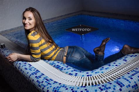 fully clothed wet girl in striped sweater tight jeans and tights in pool wetlook one