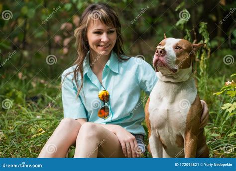 Cheerful Lady Sitting On Grass With Dog Pit Bull Stock Image Image