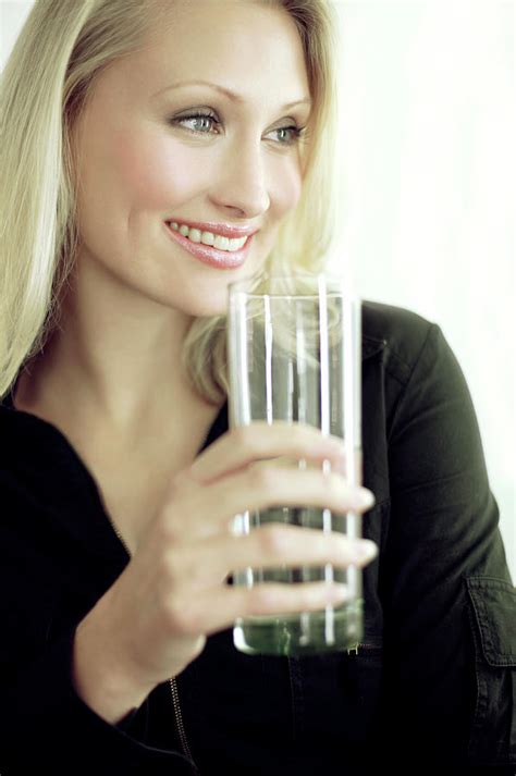 Woman Drinking A Glass Of Water Photograph By Ian Hooton Science Photo