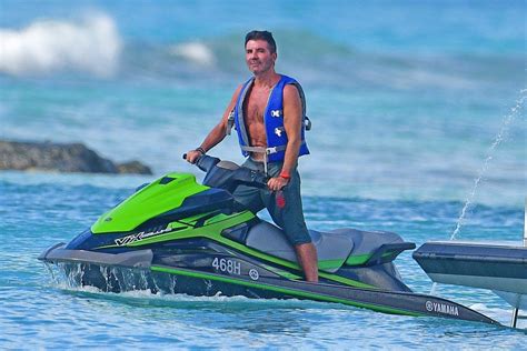 simon cowell shows off his weight loss as he rides a jet ski in barbados and lauren silverman