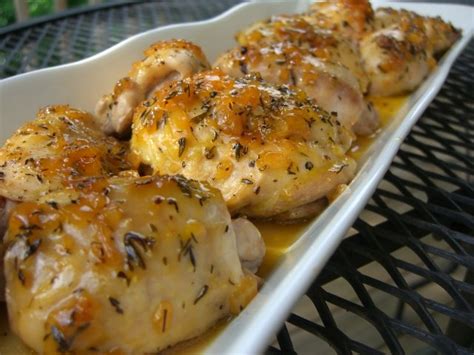 Close up shot of a chicken thigh in a casserole dish. how long to bake boneless chicken thighs at 375