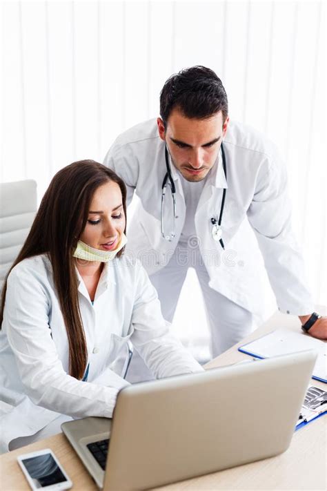 Young Medical Colleagues Working On Laptop Stock Photo Image Of