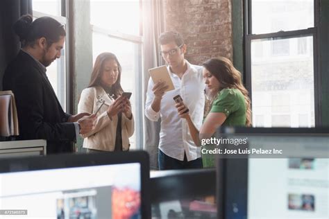 Business People Using Cell Phones And Digital Tablets In Office High