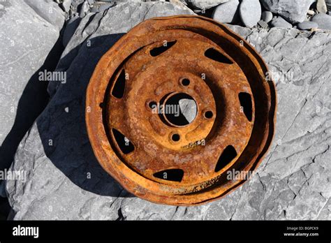 Rusty Wheel On Rocks Stock Photo Alamy