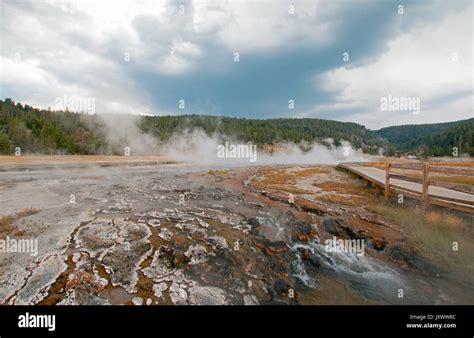 mist and vapor rising off hot cascades hot spring in the lower geyser basin in yellowstone