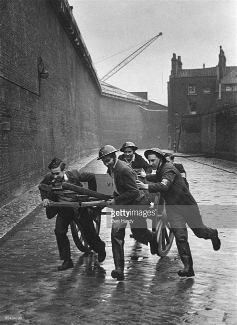 A Fire Squad Rushes Along A Dock Wall In The East End Of London To The