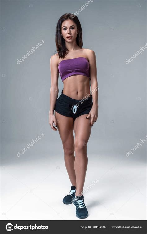 Brunette Sexy Fitness Girl In Sport Wear With Perfect Body In The Studio Posing Before Training