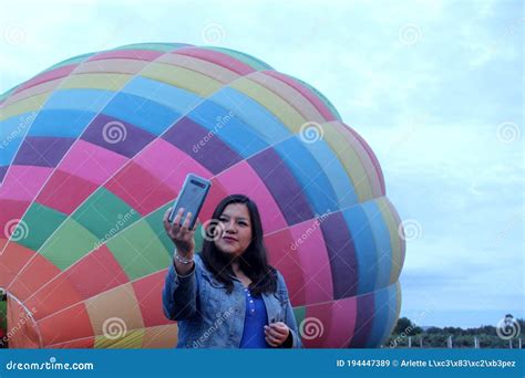 Selfie Of Latin Woman With Mobile Celebrating Anniversary In Hot Air Balloon At Sunrise Stock