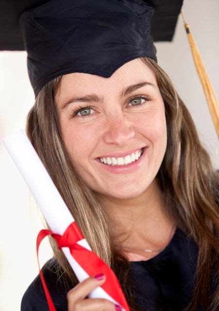 Beautiful Female Graduate Holding Her Diploma And Smiling Freestock