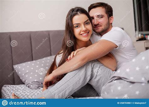 feliz jovem casal sensual deitado na cama juntos imagem de stock imagem de lifestyle namorada