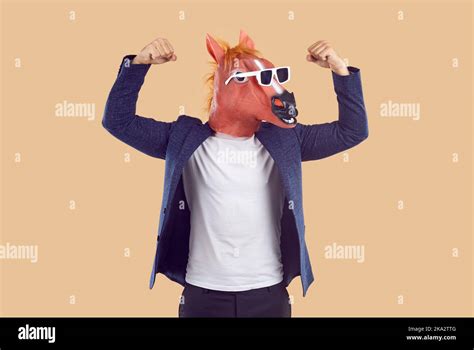 Man In Suit Funny Horse Mask And Sunglasses Shows His Strength And