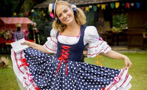 A Woman In A Blue And White Polka Dot Dress Is Posing For The Camera