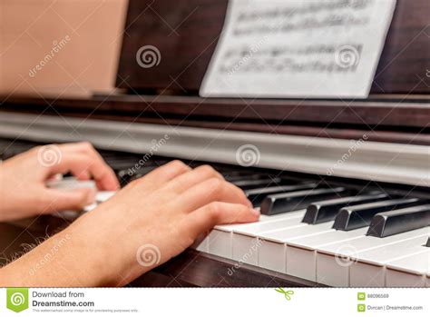 Hands Of A Little Girl Playing The Piano Stock Image